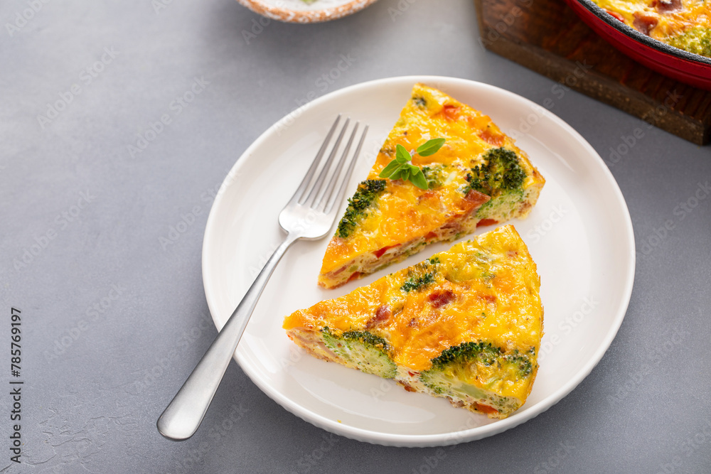 Healthy frittata or quiche with broccoli and red pepper, two slices on plate