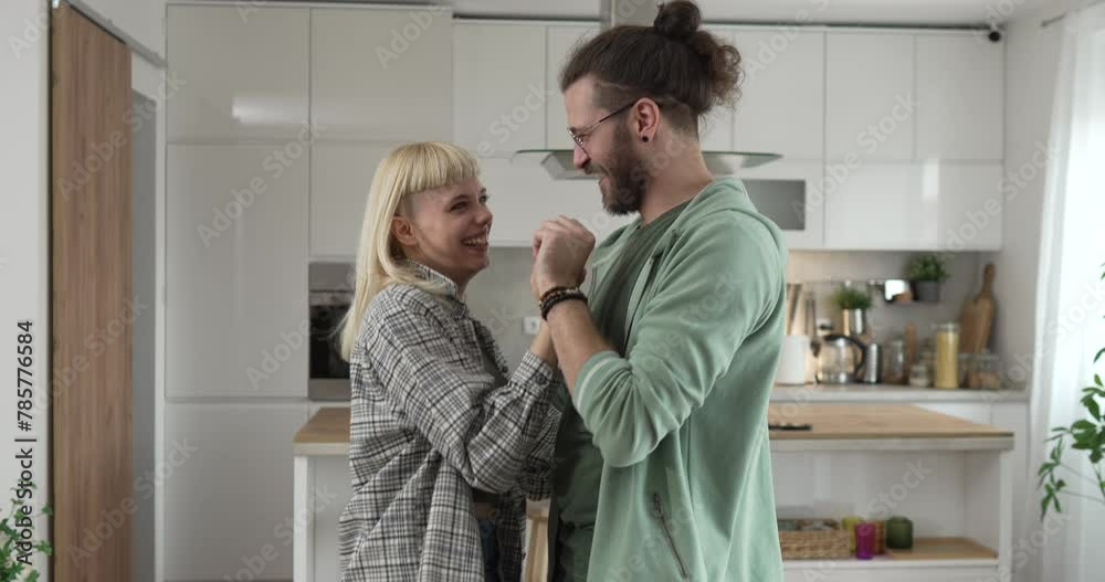 One adult couple dance together and have fun at living room at home One adult couple dance together and have fun at living room at home