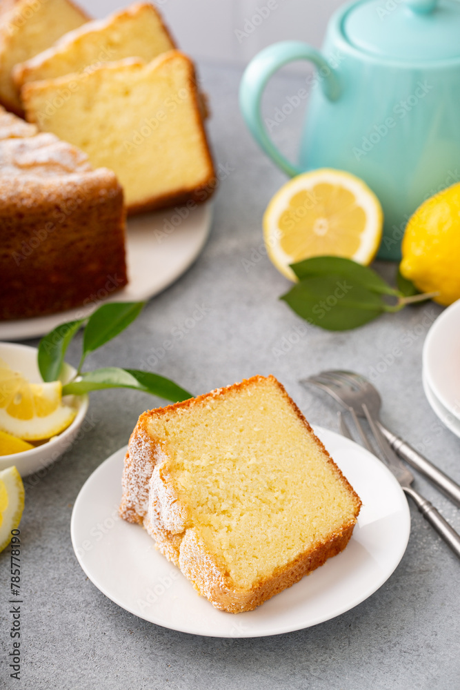 Lemon pound cake baked in a bundt pan topped with powdered sugar Lemon pound cake baked in a bundt pan topped with powdered sugar
