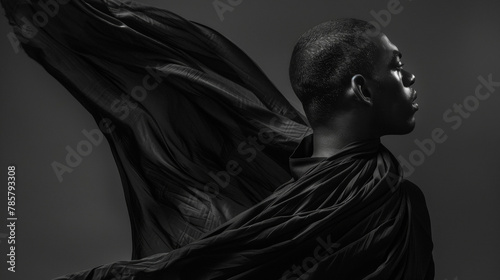 A man with deep soulful eyes gazes off into the distance as he poses in a dark flowing garment. Every movement he makes seems to be in tune with the melody of the music creating a .