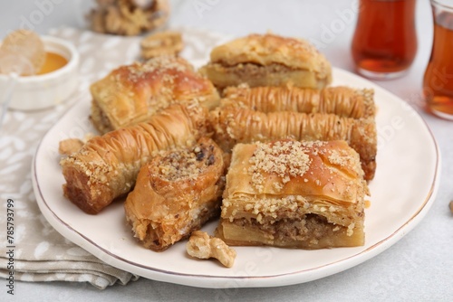 Eastern sweets. Pieces of tasty baklava on white table, closeup