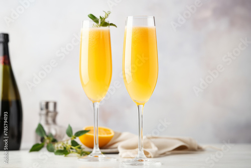 Classic mimosa or bellini cocktail in flute glasses, brunch cocktails with champagne wine with copy space