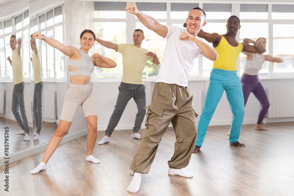 Fototapeta premium Active young Asian man practicing Capoeira dance in training hall during dancing classes