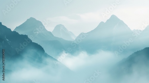 A hazy and blurred background image featuring towering mountains veiled in a thick fog evoking a sense of mystery and wonder. .