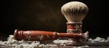 Shaving brush and powder on a wooden table. Dark background.