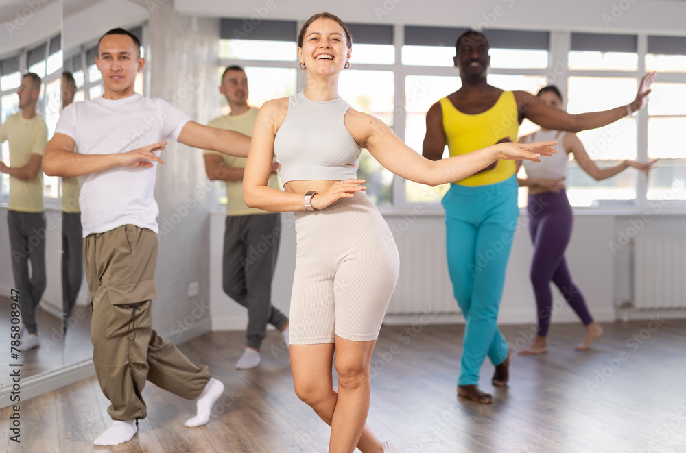 Fototapeta premium Group of multicultural men and women dancing jazz funk in studio