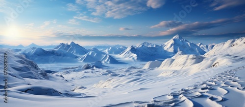 Beautiful winter mountains panorama with snow covered peaks and blue sky © WaniArt