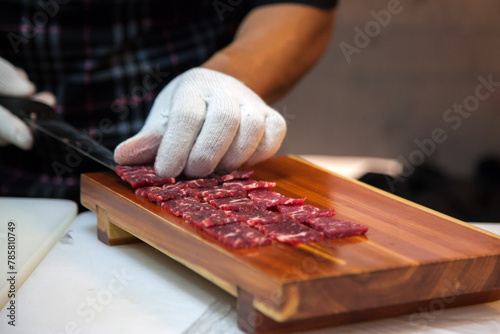 preparing the beef sashimi on the wooden board