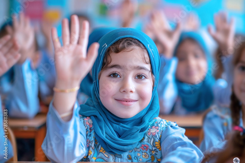 Arab school girl raised hand to answer a teacher's question in a classroom