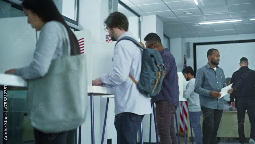 Man in glasses comes to voting booths in polling station office. National Election Day in United States. Political races of US presidential candidates. Civic duty and patriotism concept. Dolly shot. Man in glasses comes to voting booths in polling station office. National Election Day in United States. Political races of US presidential candidates. Civic duty and patriotism concept. Dolly shot.