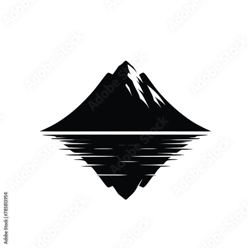 silhouette of a mountain reflected in a calm lake below