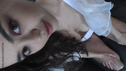 CFC2022VV  Ukrainian female model in casual setting dressed in white lingerie with feathery wings 4K in vertical format