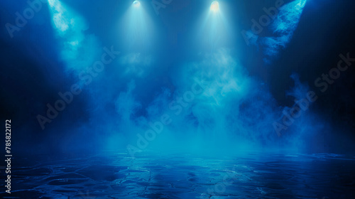 A blue room with blue lights and smoke. The lights are shining on the floor and the smoke is floating in the air