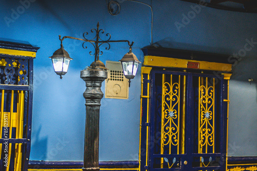 Colorful streets of Guatape, Colombia at night. Painted walls, colorful doors.