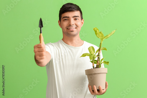 Young man with shovel and p...