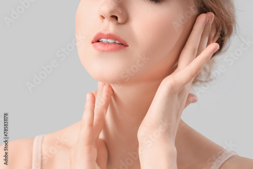 Beautiful young woman on light background, closeup