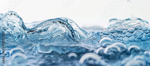 Close-up view of a vibrant blue liquid with bubbles floating to the surface, creating a mesmerizing pattern