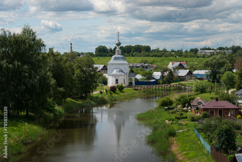 Panoramic view of the Kamenka River and the Church of the Epiphany of Christ (Epiphany Church) in Kozhevennaya Sloboda on a sunny summer day, Suzdal, Vladimir region, Russia photo