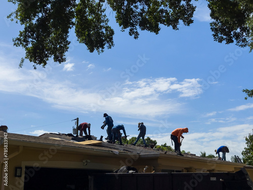 Men working on the roof of a house, Plantation, Florida, USA