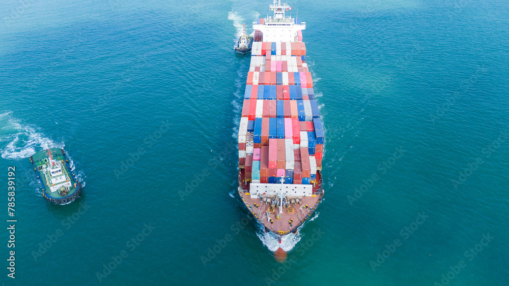Cargo Container Ship was pulling by Tugboat. container ship import export to customers sea port. export shipping industry freight and transportation logistics concept