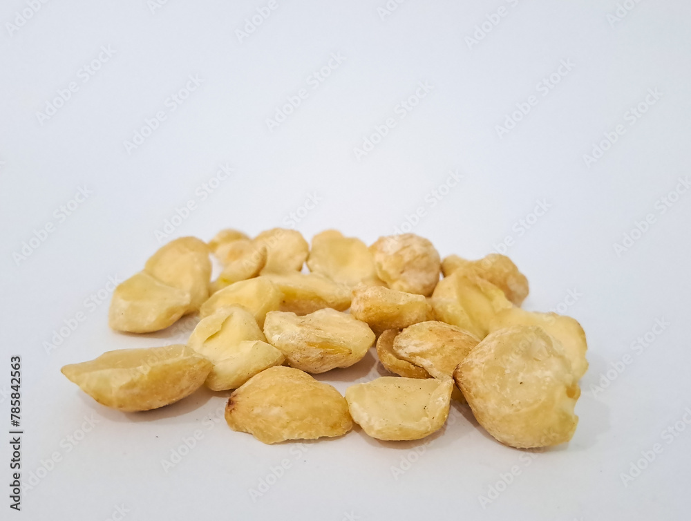 Fototapeta premium Aleurites moluccanus or Indonesian Candlenuts called Kemiri, inside a smale plate, isolated in white background