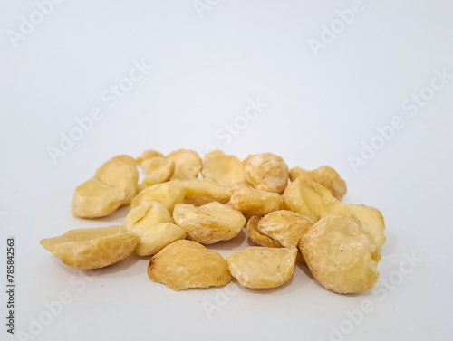 Aleurites moluccanus or Indonesian Candlenuts called Kemiri, inside a smale plate, isolated in white background