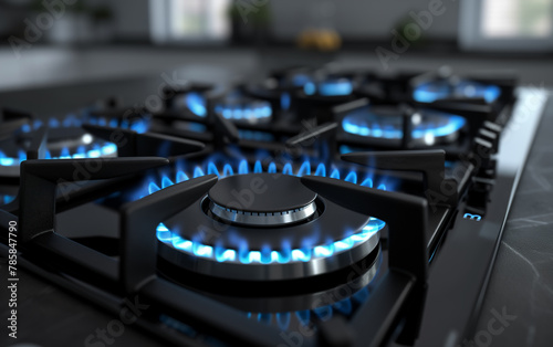 Close up of blue flames burning on gas stove. Panel from steel with a gas ring burner.