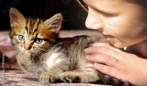 Portrait of cute girl with funny kitten, face to face, close up. Domestic cat and child. Love, care, talking with friends