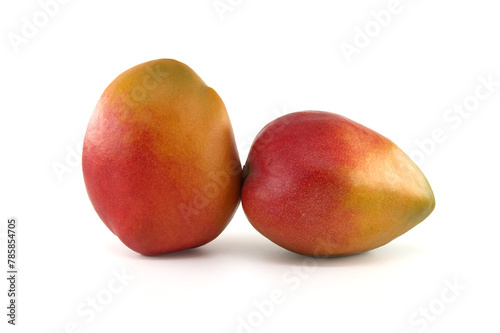 Two ripe vibrant colors mango fruits isolated on white