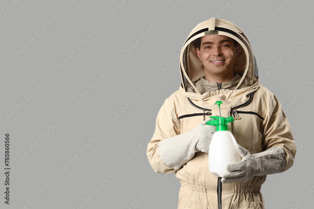 Male beekeeper with sprayer on light background Male beekeeper with sprayer on light background