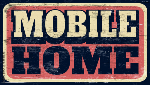 Aged and worn vintage mobile home sign on wood