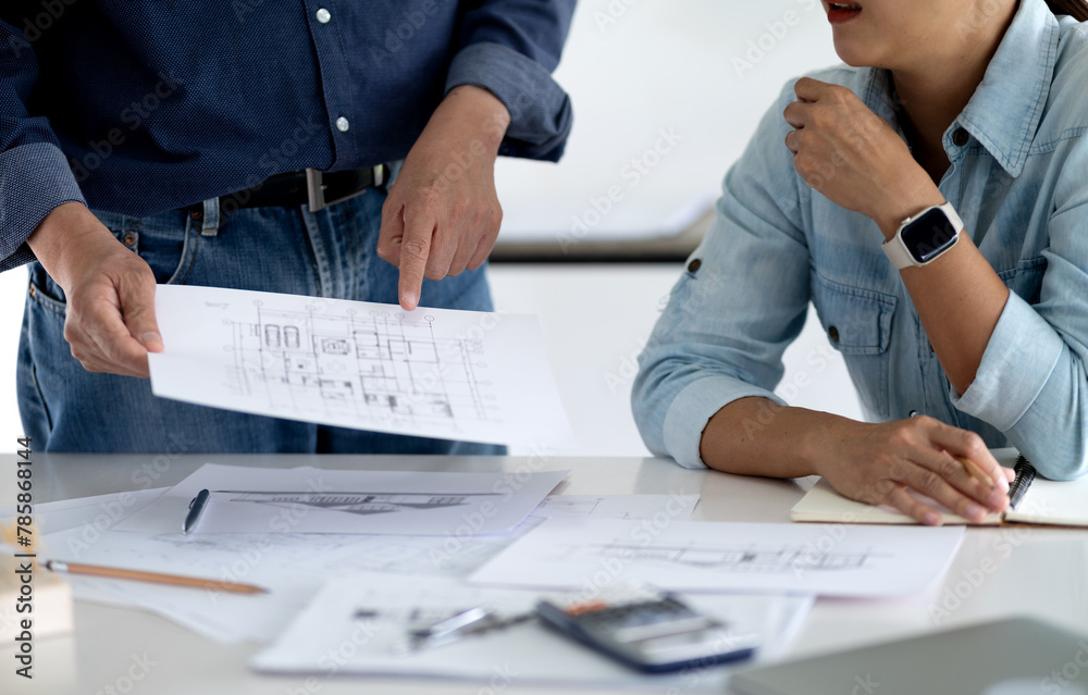 Architect or engineer is looking at and checking the details of the building Architect or engineer is looking at and checking the details of the building