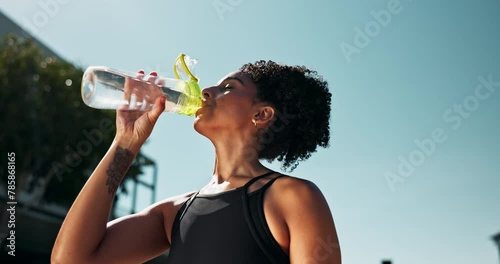 Fitness, wellness and woman drinking water for hydration, workout and training for health outside. Tired runner, cardio exercise and liquid for resting or energy, break and active in summer