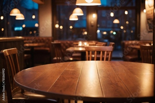 Close-up of a table in the empty cozy cafe in the evening with warm light. Blurred background with copy space.