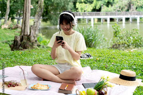 teenage girl is sitting happily relaxing and listening to music with headphones