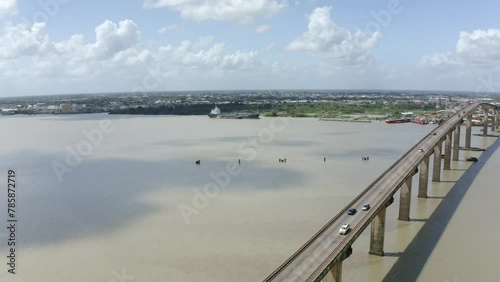 Wallpaper Mural Wide angle aerial shot of Jules Wijdenbosch Bridge between Paramaribo and Meerzorg in Suriname, South America, with traffic as drone gains backwards Torontodigital.ca