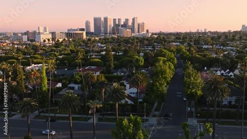 Aerial Shot of Beverly Hills Intersection with Wilshire Buildings on Horizon, Cars Driving Along Tree Lined Streets