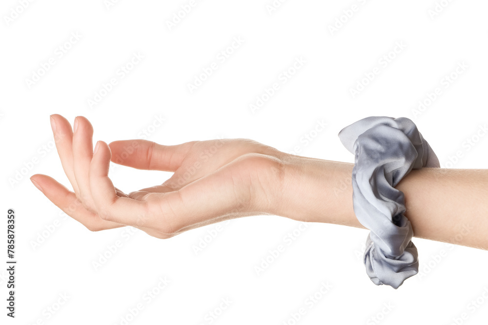 Obraz premium Female hand with trendy silk scrunchy on white background