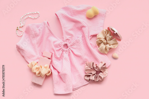 Female t-shirt with trendy silk scrunchies, perfume bottle and necklace on pink background