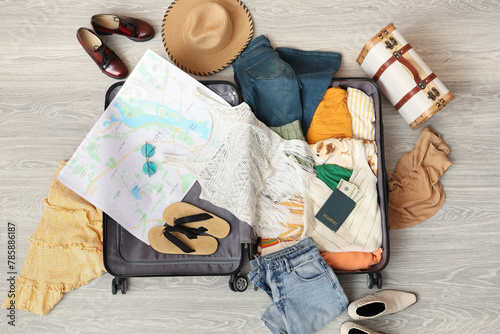 Open suitcase with female c...