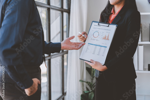 Financial analyst analyzes business finance reports on laptop and graph documents during corporate meeting discussions showing successful teamwork, business meeting ideas, marketing.