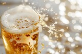 Pouring beer into glass with splashes, bokeh background