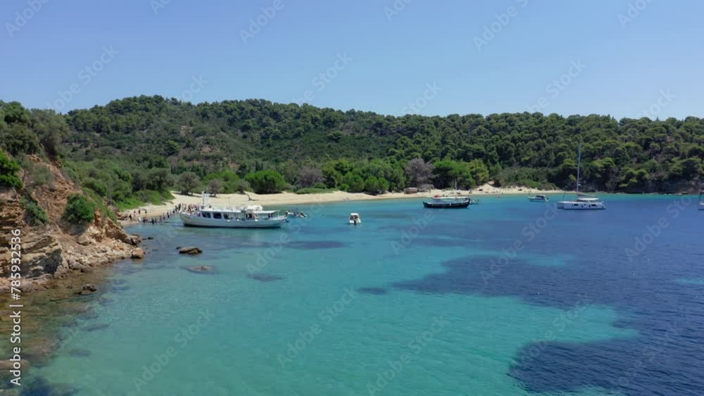 Aerial: Flying towards Tsougkria island beach where tourist boats and sailboats are moored Aerial: Flying towards Tsougkria island beach where tourist boats and sailboats are moored