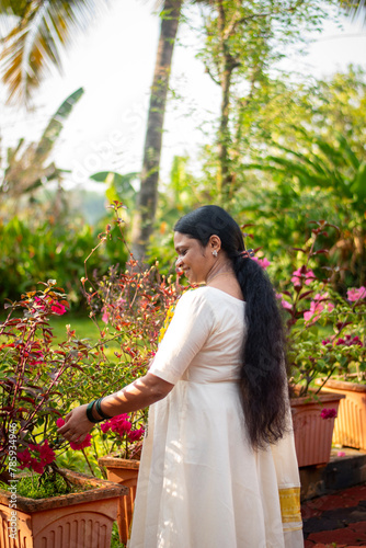 A Picture of middle aged malayali woman making Vishu kani photo