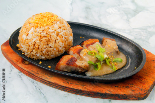 Freshly cooked fried pork belly served with garlic rice and gravy