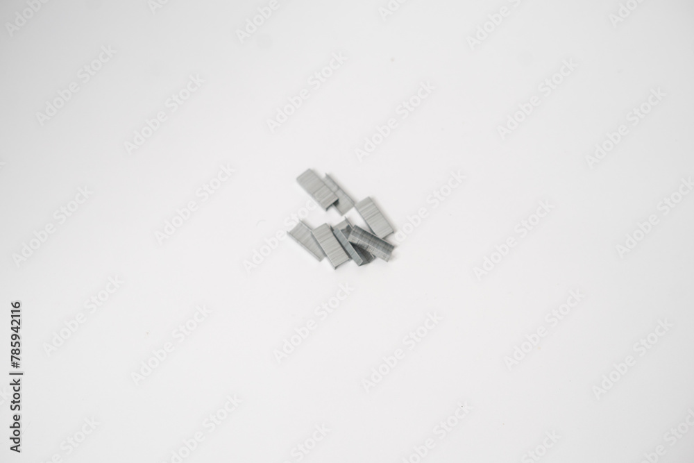 The contents of the stapler are collected severally on a white background The contents of the stapler are collected severally on a white background