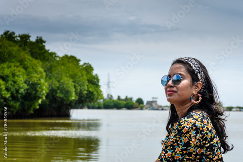 Young Indian woman boating through Pichavaram Mangrove Forests. The second largest Mangrove forest in the world, located near Chidambaram in Cuddalore District, Tamil Nadu, India