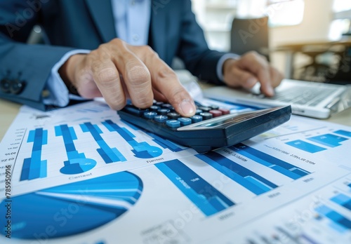 "Calculating Financial Success: Businessman Analyzing Data with Coins on Table"