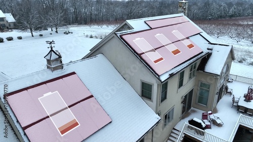 Low energy generation from solar panels covered in snow during winter. Animated aerial drone shot of large American home with red battery symbols on inefficient renewable energy source