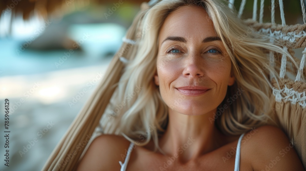 Serene Blonde Woman Relaxing in a Hammock at Tropical Beach Serene Blonde Woman Relaxing in a Hammock at Tropical Beach